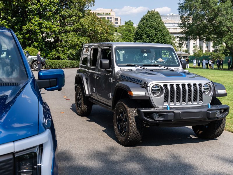 President Biden is pictured behind the wheel of a grey Jeep in front of the White House